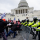 Insurrectionists loyal to President Donald Trump try to break through a police barrier, Wednesday, Jan. 6, 2021, at the Capitol in Washington. Facing prison time and dire personal consequences for storming the U.S. Capitol, some Jan. 6 defendants are trying to profit from their participation in the deadly riot, using it as a platform to drum up cash, promote business endeavors and boost social media profiles.